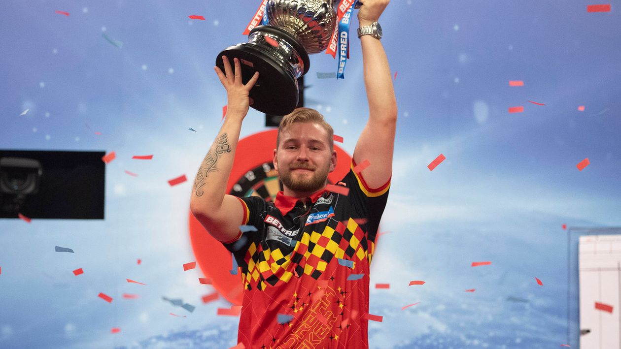 Dimitri Van den Bergh lifts the World Matchplay trophy (Picture: Lawrence Lustig/PDC)