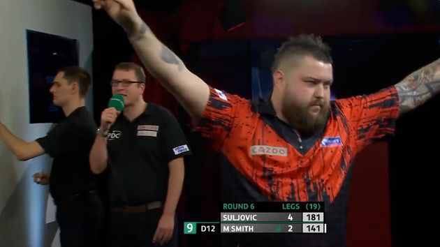 Michael Smith celebrates after bagging a nine-dart finish (ITV)