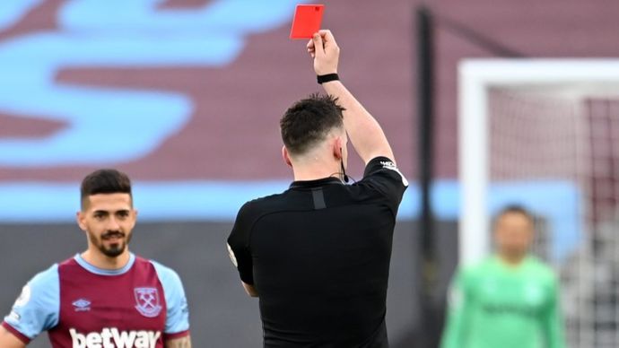 Referee Chris Kavanagh shows a red card to West Ham's Fabian Balbuena