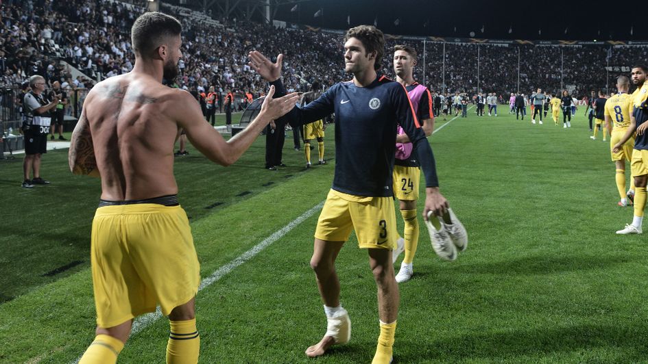 Olivier Giroud and Marcos Alonso celebrate after victory away at PAOK