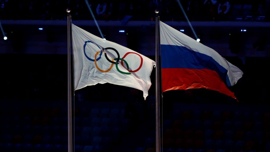 The Olympic flag flies next to the Russia flag