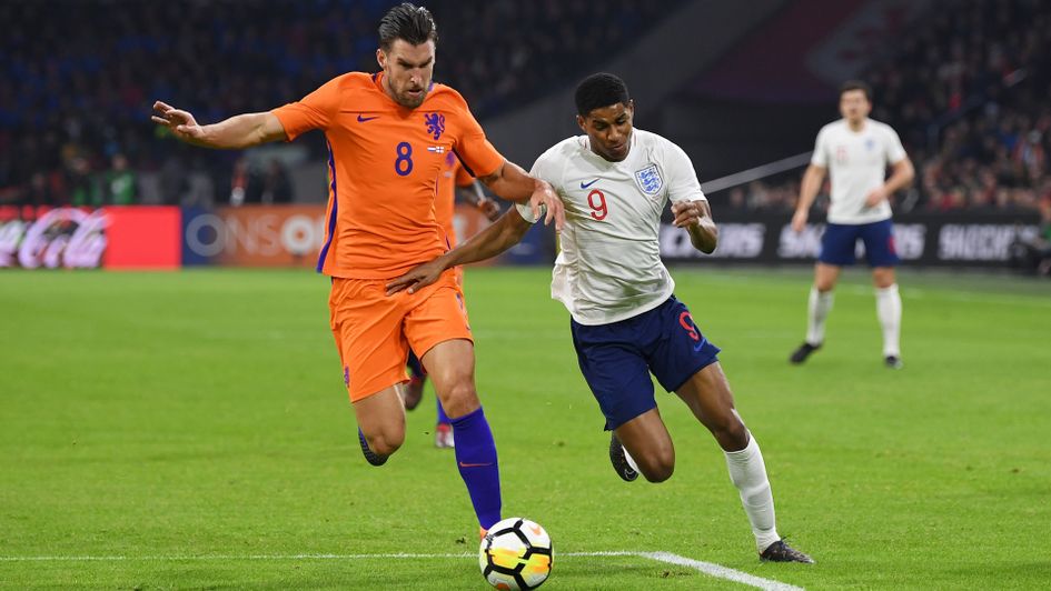 Kevin Strootman keeps track of Marcus Rashford