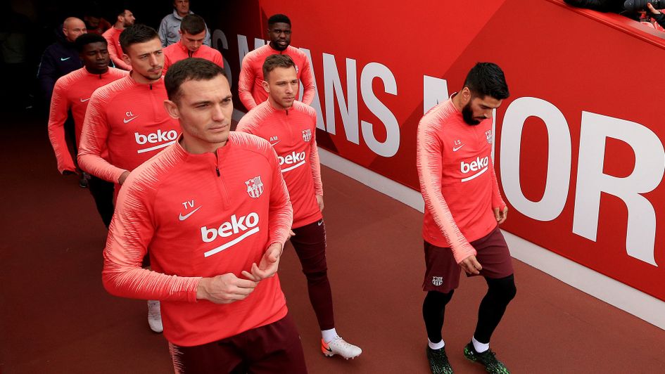 Luis Suarez (right) walks out for a training session at Anfield