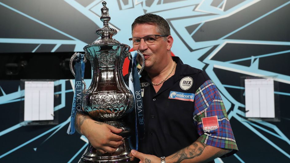 Gary Anderson kisses the Phil Taylor Trophy aloft after winning the World Matchplay (Picture: PDC/Lawrence Lustig)