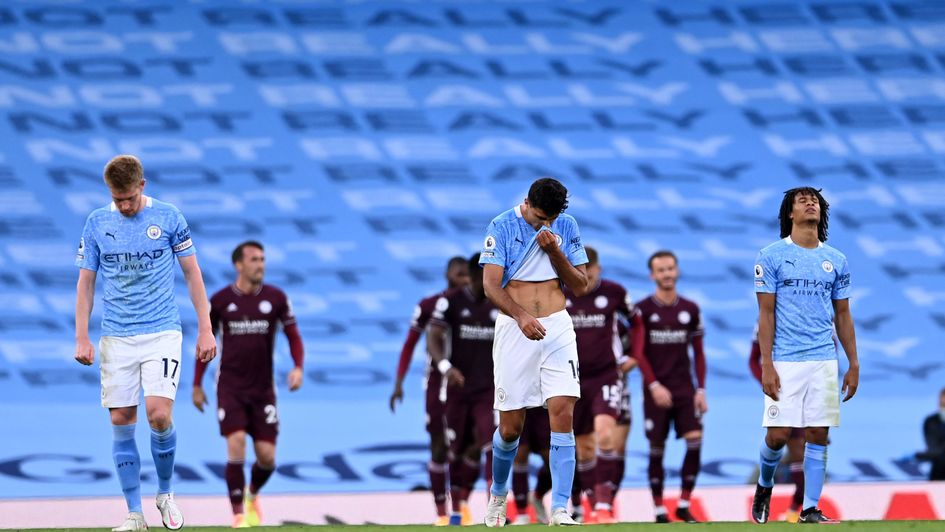 Man City trio Kevin De Bruyne (L), Rodri (C) and Nathan Ake (R) react to conceding another goal against Leicester