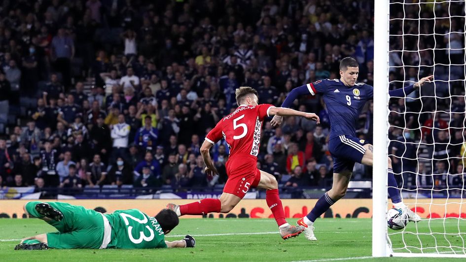 Lyndon Dykes scores against Moldova