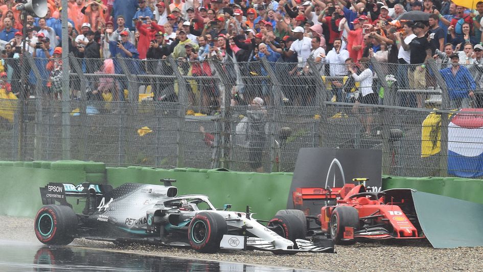 Lewis Hamilton comes off the track as passes the car of Charles Leclerc