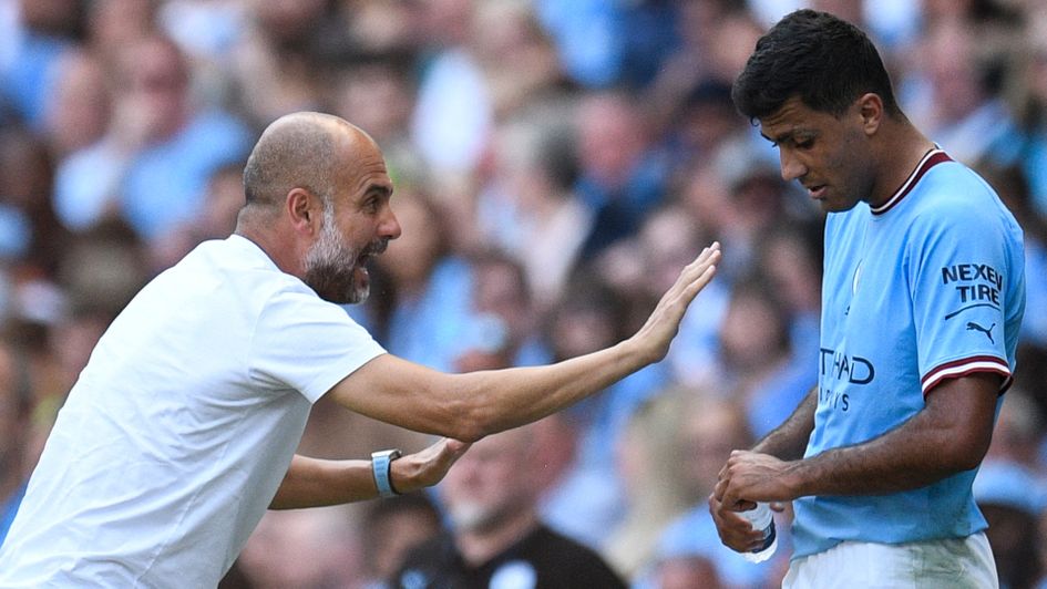 Pep Guardiola gives instruction to Rodri