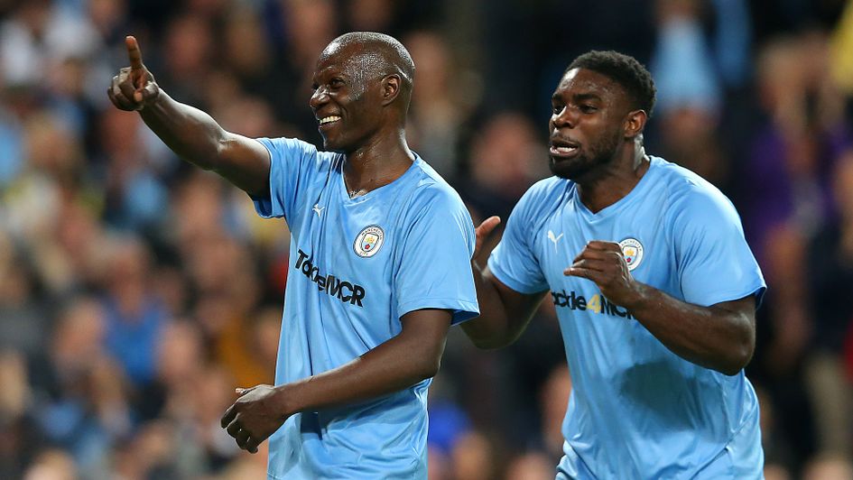 Benjani of Manchester City Legends celebrates with team mate Micah Richards after scoring