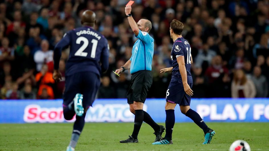 Mike Dean brandishes a red card - arguably the highlight of the match