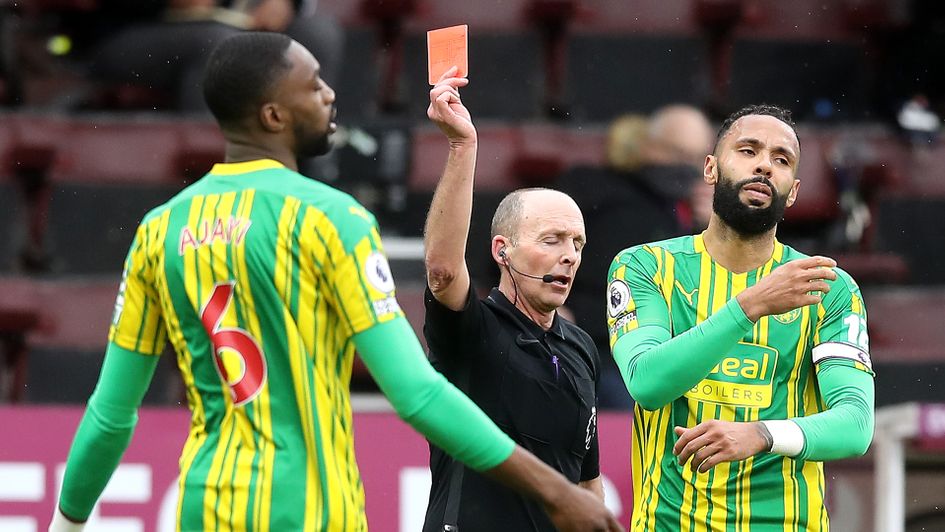 Mike Dean shows a red card to Semi Ajayi