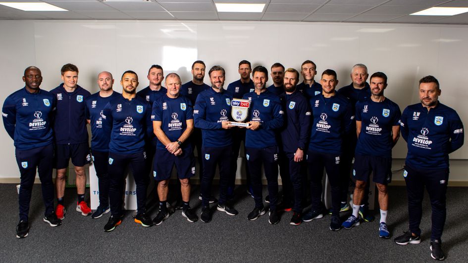 Nicky and Danny Cowley (centre, left and right): Huddersfield staff, pictured with the Manager of the Month award for October 2019