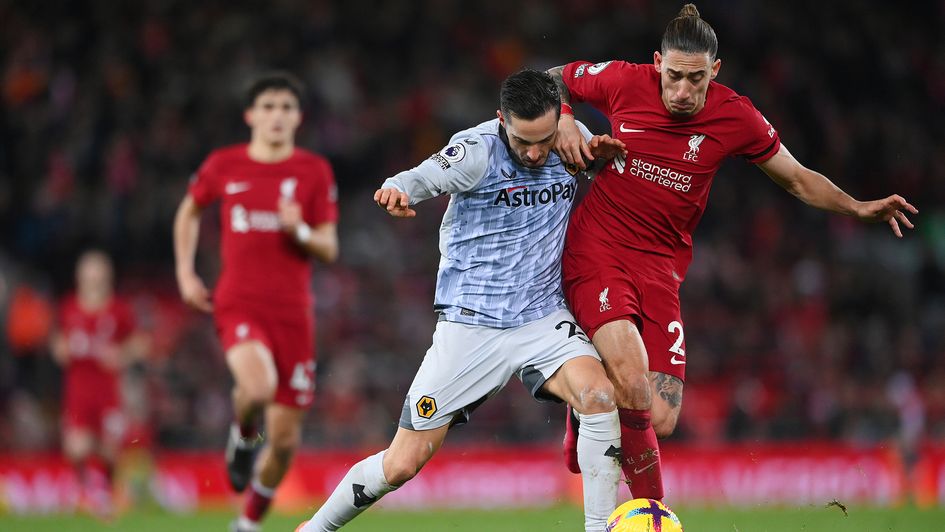 Pablo Sarabia battles for possession with Kostas Tsimikas