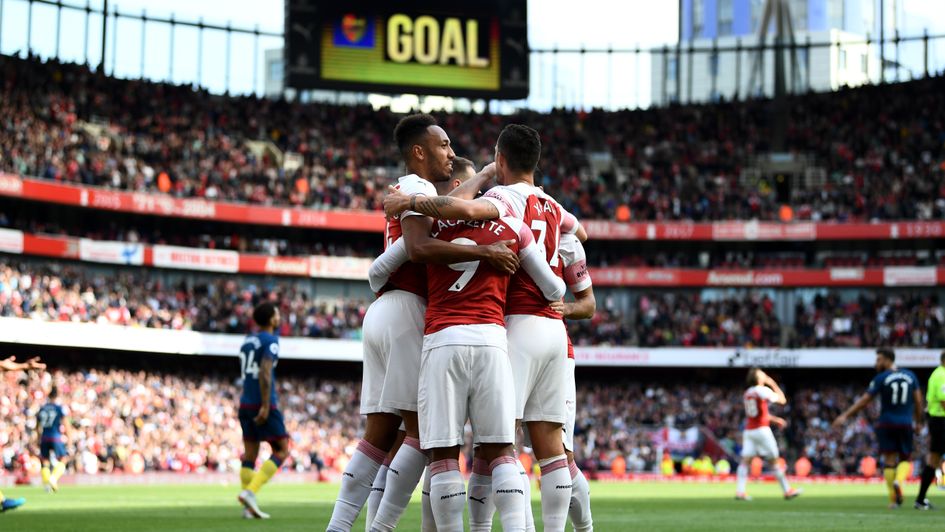 Arsenal players celebrate after taking the lead against West Ham