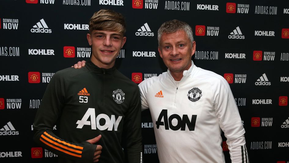 Brandon Williams poses with Manchester United boss Ole Gunnar Solskjaer after signing his new deal