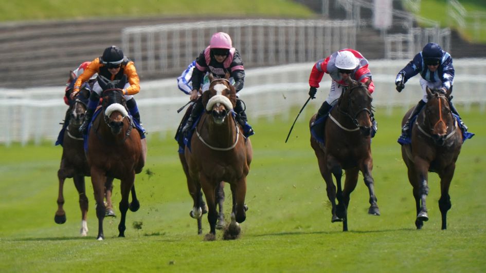 Look Out Louis ridden by jockey Jason Hart (centre, pink cap) comes home in front