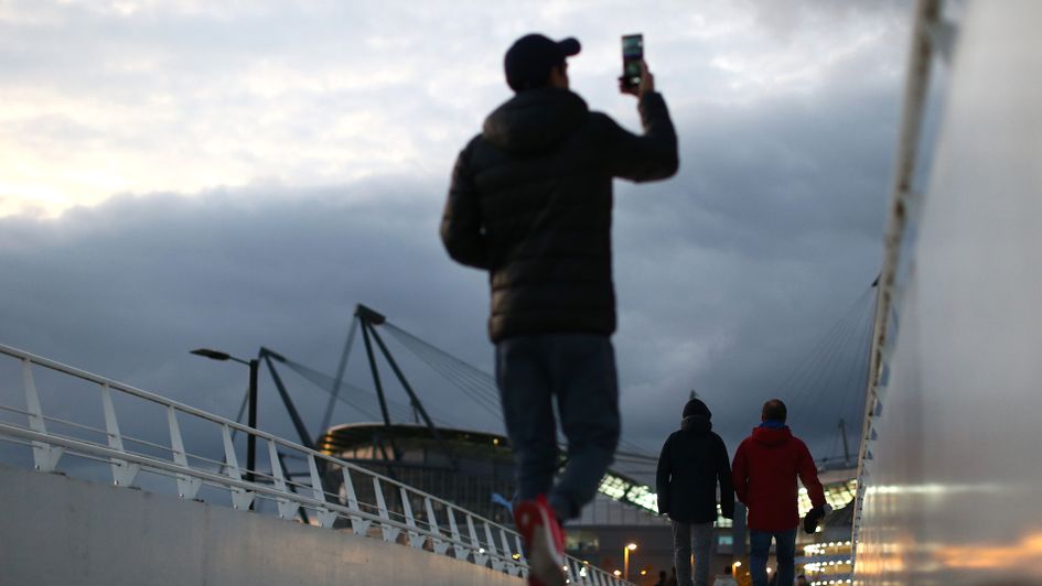 Fans make their way to the Etihad Stadium