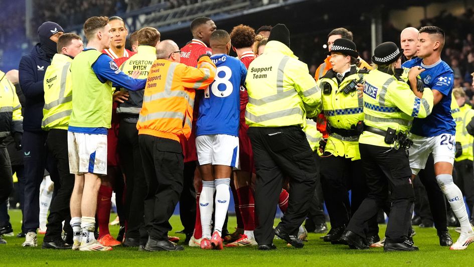 Everton and Liverpool players clash