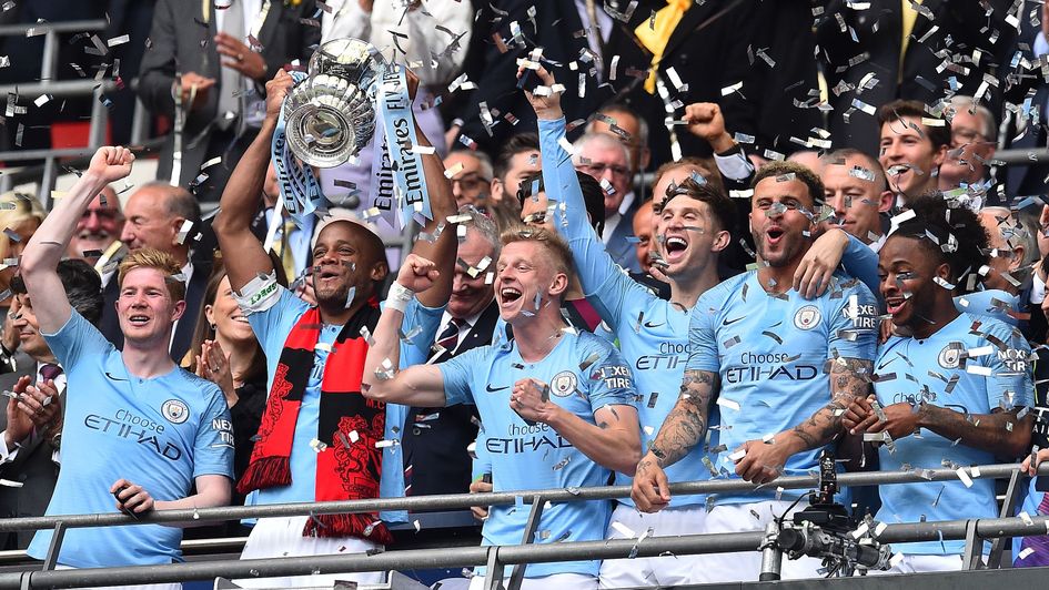 Vincent Kompany lifts the FA Cup as Man City secure a historic treble