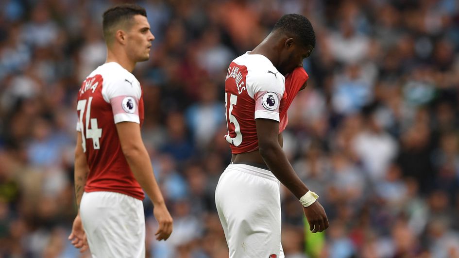 Ainsley Maitland-Niles: The defender (right) limps off against Manchester City
