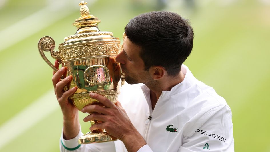 Novak Djokovic kisses the Wimbledon trophy