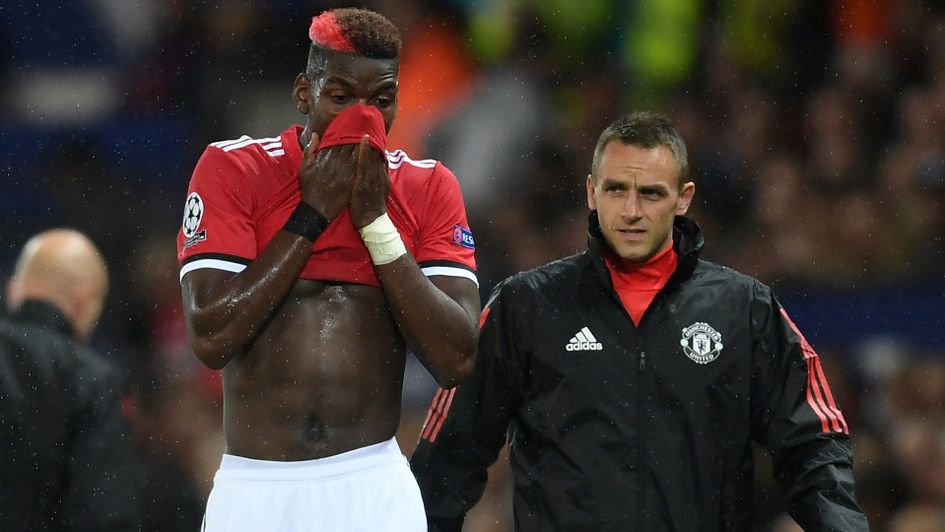Paul Pogba reacts after leaving the field through injury