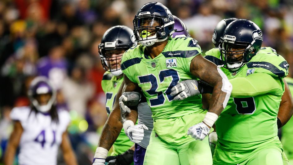 Seattle Seahawks' Chris Carson (number 32) celebrates a touchdown