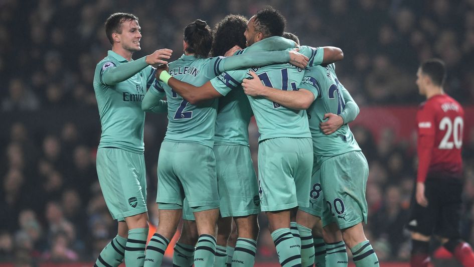Arsenal players celebrate at Old Trafford