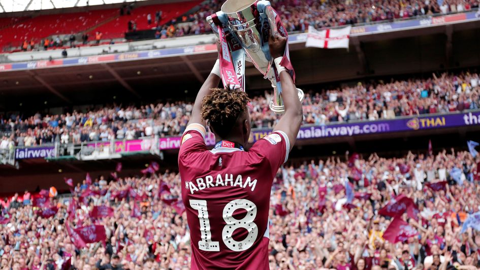 Tammy Abraham lifts the trophy to Aston Villa fans at Wembley
