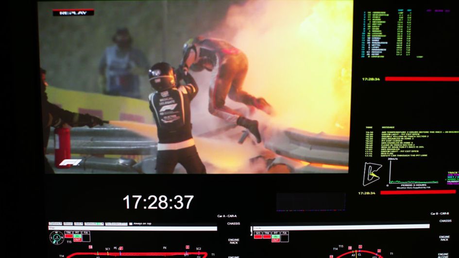 Romain Grosjean is helped to safety