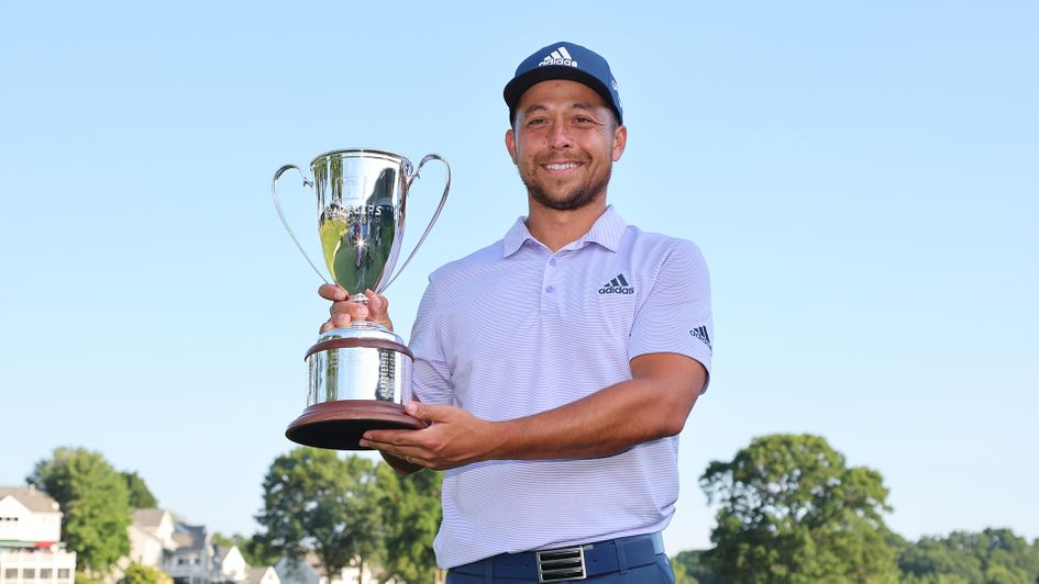 Xander Schauffele poses with the trophy after winning the Travelers Championship