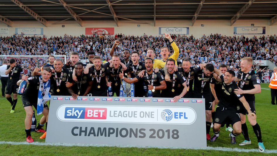 Wigan players celebrate after winning the Sky Bet League One title