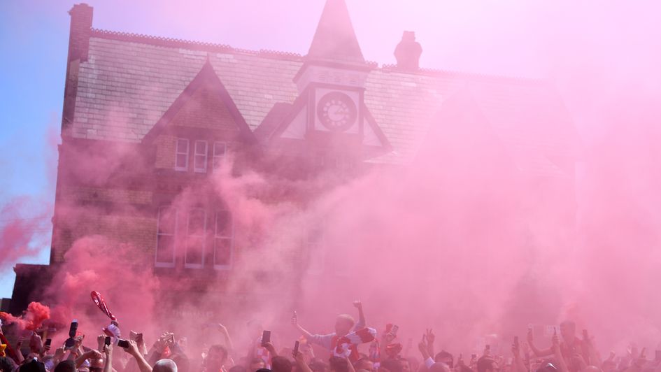 Liverpool fans welcome their team bus to Anfield ahead of their Premier League showdown with Wolves