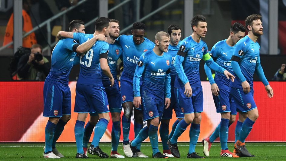 Arsenal players celebrate in Milan
