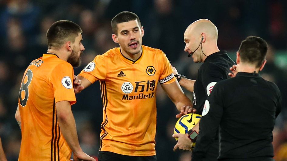 Conor Coady talks to referee Anthony Taylor after VAR decision as Wolves lose at Liverpool