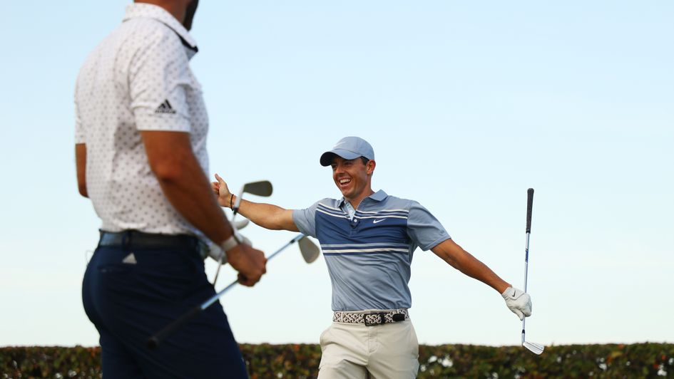 Rory McIlroy (right) celebrates victory in the TaylorMade Driving Relief skins tournament with Dustin Johnson