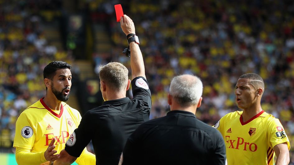 Miguel Britos (left) receives a red card