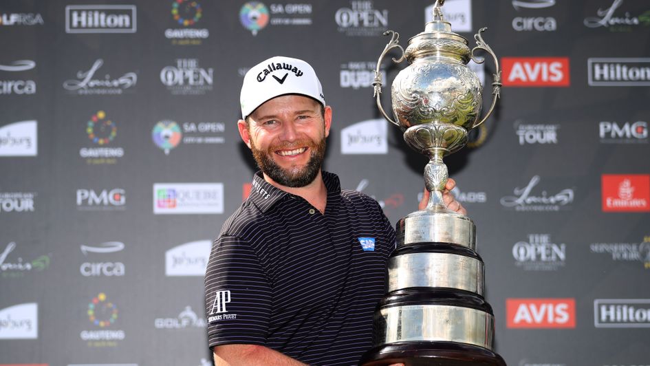 Branden Grace poses with the trophy