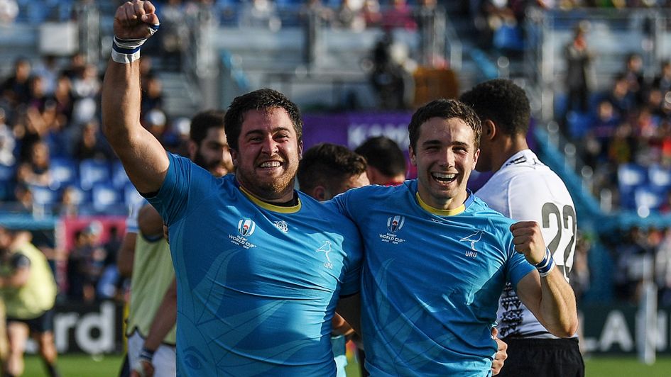 Uruguay's full back Felipe Etcheverry, right, and prop Facundo Gattas celebrate after beating Fiji