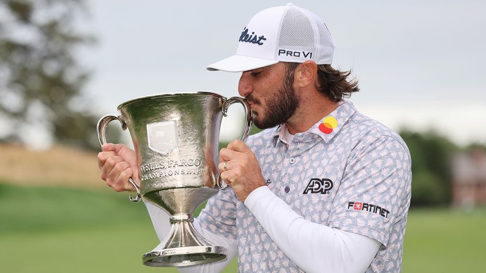 Max Homa celebrates with the trophy after winning the Wells Fargo Championship