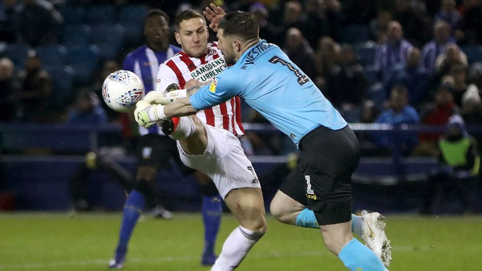 Sheffield United's Billy Sharp challenges Sheffield Wednesday goalkeeper Keiren Westwood for the ball