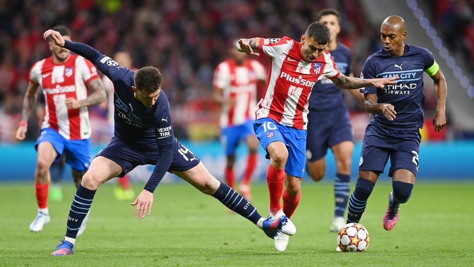 Aymeric Laporte battles for possession with Angel Correa