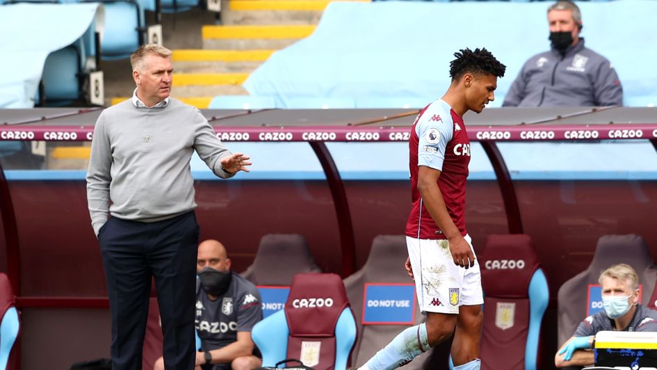 Ollie Watkins walks past Dean Smith after being sent off against Manchester United