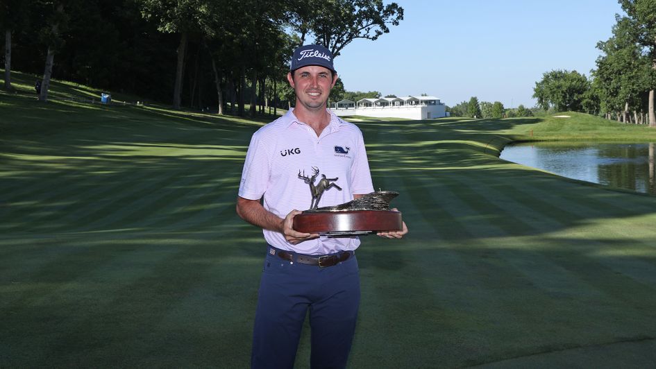J.T. Poston poses with the trophy after winning the John Deere Classic