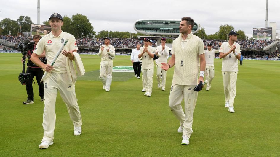 Chris Woakes (left) and James Anderson lead England off the field