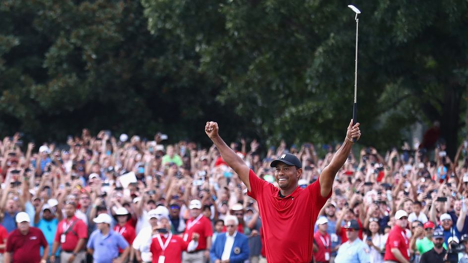 Arms aloft: Tiger Woods celebrates his first PGA Tour win since 2013