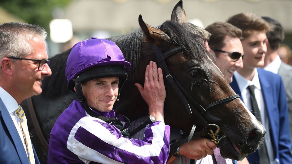 Ryan Moore and U S Navy Flag pose for a photograph