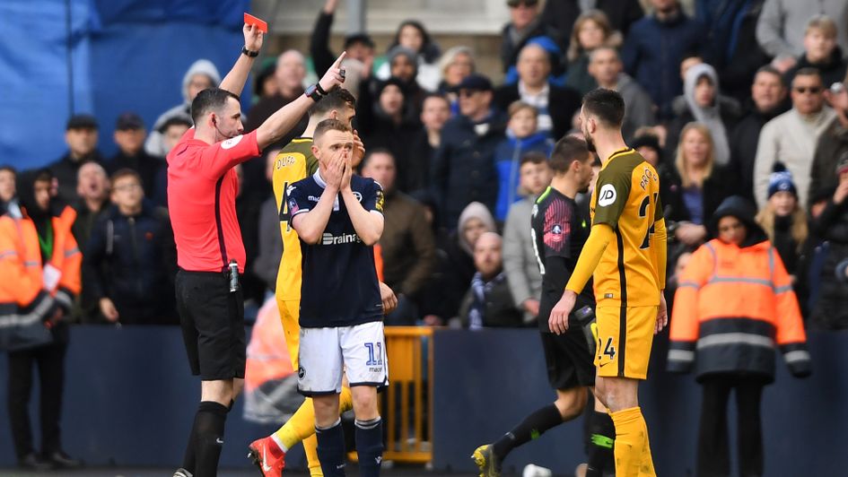 Shane Ferguson is shown a red card