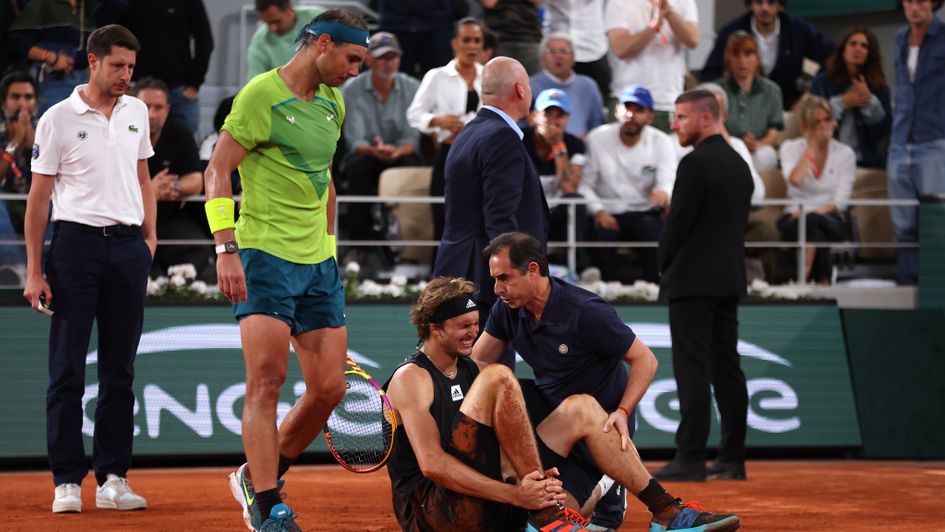 Rafa Nadal looks on as Alexander Zverev is forced to retire