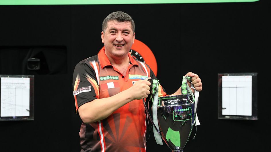 Mensur Suljovic with the Champions League of Darts trophy (Lawrence Lustig, PDC)